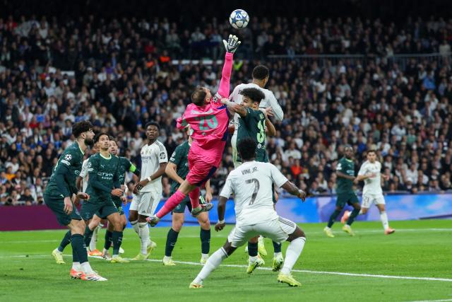 Manchester City's Italian goalkeeper #25 Gianluigi Donnarumma reaches for the ball during the UEFA Champions League league phase day 6 football match between Real Madrid CF and Manchester City at Santiago Bernabeu Stadium in Madrid on December 10, 2025. (Photo by Thomas COEX / AFP)
