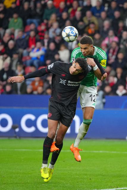 Bayer Leverkusen's English defender #04 Jarell Quansah and Newcastle United's German defender #12 Malick Thiaw jump for the ball during the UEFA Champions League league phase - matchday 6, football match between Bayer Leverkusen and Newcastle United FC at the BayArena stadium in Leverkusen, western Germany on December 10, 2025. (Photo by Pau Barrena / AFP)