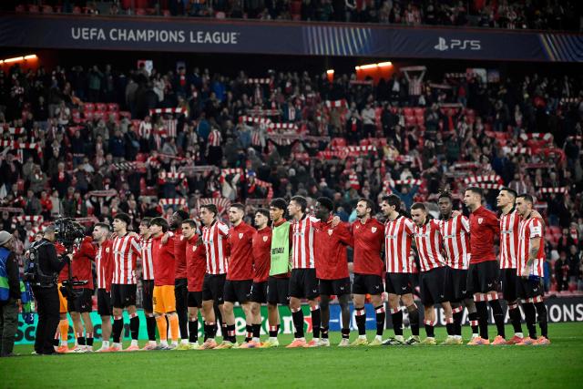 Athletic Club Bilbao's players cheer at the end of the UEFA Champions League league phase day 6 football match between Athletic Club Bilbao and Paris Saint-Germain (PSG) at San Mames Stadium in Bilbao on December 10, 2025. The match ended in a draw 0-0. (Photo by ANDER GILLENEA / AFP)