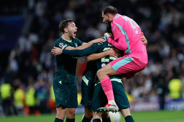 TOPSHOT - Manchester City's Italian goalkeeper #25 Gianluigi Donnarumma (R) celebrates with Manchester City's Spanish midfielder #14 Nico Gonzalez after the UEFA Champions League league phase day 6 football match between Real Madrid CF and Manchester City at Santiago Bernabeu Stadium in Madrid on December 10, 2025. (Photo by Oscar DEL POZO / AFP)