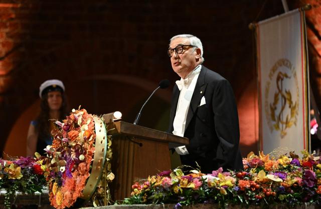 laureate of The Sveriges Riksbank Prize in Economic Sciences 2025 US-Israeli economic historian Joel Mokyr addresses a speech at the end of the Nobel Prize banquet on December 10, 2025 at the City Hall in Stockholm, Sweden. The laureates received their prizes at formal ceremonies in Stockholm and Oslo on December 10. That date is the anniversary of the death in 1896 of scientist Alfred Nobel, who created the prizes in his will. (Photo by Jonathan Nackstrand / AFP)