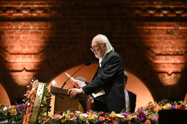 Nobel Prize in Literature 2025 laureate Hungarian writer Laszlo Krasznahorkai addresses a speech at the end of the Nobel Prize banquet on December 10, 2025 at the City Hall in Stockholm, Sweden. The laureates received their prizes at formal ceremonies in Stockholm and Oslo on December 10. That date is the anniversary of the death in 1896 of scientist Alfred Nobel, who created the prizes in his will. (Photo by Jonathan Nackstrand / AFP)
