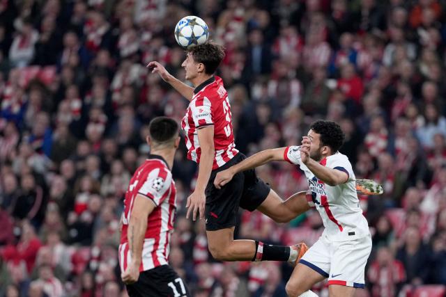 Athletic Bilbao's Spanish midfielder #31 Asier Hierro jumps for the ball during the UEFA Champions League league phase day 6 football match between Athletic Club Bilbao and Paris Saint-Germain (PSG) at San Mames Stadium in Bilbao on December 10, 2025. (Photo by Cesar MANSO / AFP)