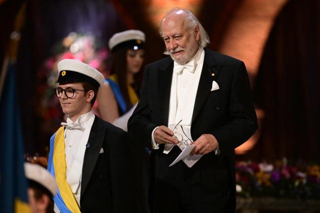 Nobel Prize in Literature 2025 laureate Hungarian writer Laszlo Krasznahorkai (R) is pictured during the Nobel Prize banquet on December 10, 2025 at the City Hall in Stockholm, Sweden. The laureates received their prizes at formal ceremonies in Stockholm and Oslo on December 10. That date is the anniversary of the death in 1896 of scientist Alfred Nobel, who created the prizes in his will. (Photo by Jonas EKSTROMER / TT News Agency / AFP) / Sweden OUT