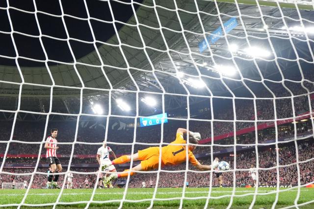 TOPSHOT - Athletic Bilbao's Spanish goalkeeper #01 Unai Simon deflects the ball during the UEFA Champions League league phase day 6 football match between Athletic Club Bilbao and Paris Saint-Germain (PSG) at San Mames Stadium in Bilbao on December 10, 2025. (Photo by CESAR MANSO / AFP)