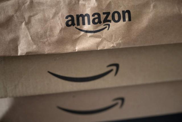 (FILES) The logo of e-commerce company Amazon is pictured on parcels in Manta, Northwestern Italy, on March 29, 2024. Amazon said on December 10, 2025 it had reached a settlement with prosecutors in Italy on a 1.2-billion-euro tax-evasion case, with Italian media reporting the online retail giant would pay out 511 million euros ($596 million). (Photo by MARCO BERTORELLO / AFP)