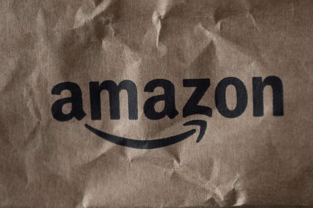 (FILES) The logo of e-commerce company Amazon is pictured on parcels in Manta, Northwestern Italy, on March 29, 2024. Amazon said on December 10, 2025 it had reached a settlement with prosecutors in Italy on a 1.2-billion-euro tax-evasion case, with Italian media reporting the online retail giant would pay out 511 million euros ($596 million). (Photo by MARCO BERTORELLO / AFP)