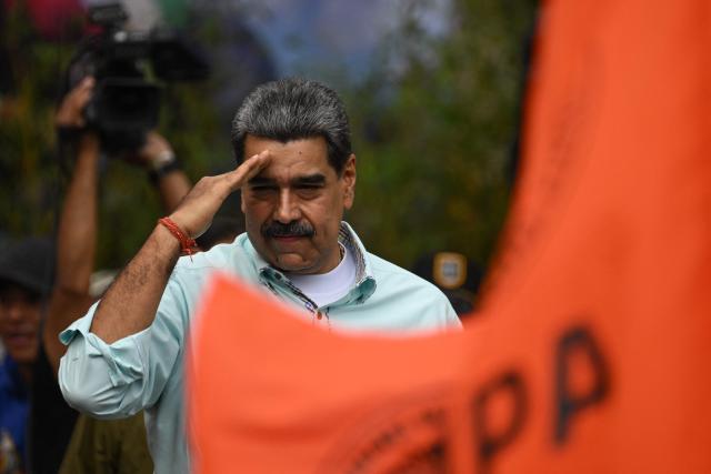 Venezuela's President Nicolas Maduro gestures during a rally to mark the anniversary of the Battle of Santa Ines, in Caracas on December 10, 2025. (Photo by Federico PARRA / AFP)
