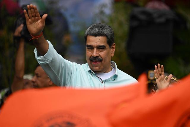Venezuela's President Nicolas Maduro gestures during a rally to mark the anniversary of the Battle of Santa Ines, in Caracas on December 10, 2025. (Photo by Federico PARRA / AFP)