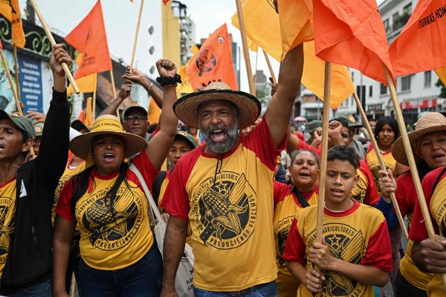 Supporters of Venezuela's President Nicolas Maduro take part in a rally to mark the anniversary of the Battle of Santa Ines, in Caracas on December 10, 2025. (Photo by Federico PARRA / AFP)