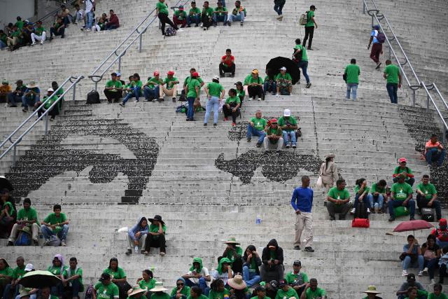 Supporters of Venezuela's President Nicolas Maduro take part in a rally to mark the anniversary of the Battle of Santa Ines, in Caracas on December 10, 2025. (Photo by Federico PARRA / AFP)