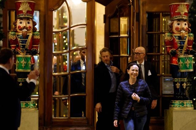 Nobel peace laureate Maria Corina Machado exits the Grand Hotel to greet supporters in Oslo, Norway, in the early hours of December 11, 2025. Machado arrived in Oslo hours after the Venezuelan opposition leader's award was collected on her behalf by her daughter. (Photo by Odd ANDERSEN / AFP)