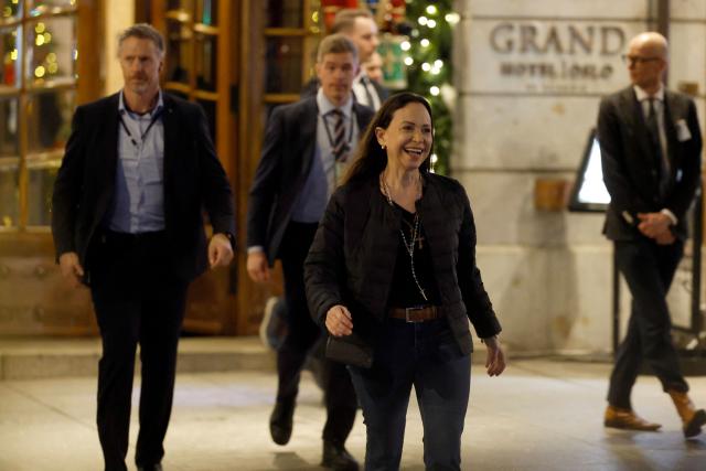 Nobel peace laureate Maria Corina Machado exits the Grand Hotel to greet supporters in Oslo, Norway, in the early hours of December 11, 2025. Machado arrived in Oslo hours after the Venezuelan opposition leader's award was collected on her behalf by her daughter. (Photo by Odd ANDERSEN / AFP)
