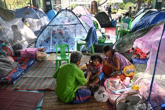 Displaced residents rest at an evacuation center in the Thai border province of Surin on December 11, 2025, during clashes along the Thai-Cambodia border. Renewed fighting raged at the border of Cambodia and Thailand on December 11, with combat heard near centuries-old temples, ahead of an expected phone call from US President Donald Trump to the two nations' leaders. (Photo by Lillian SUWANRUMPHA / AFP)