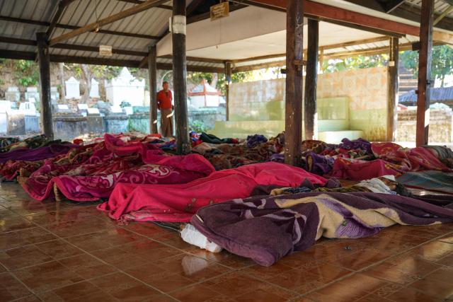 EDITORS NOTE: Graphic content / This picture shows bodies of victims of a Myanmar military air strike that killed more than 30 people at a hospital in Mrauk U, western Rakhine state on December 11, 2025. A Myanmar military air strike killed more than 30 people at a hospital, an on-site aid worker said on December 11, 2025 as the junta wages a withering offensive ahead of elections beginning this month. (Photo by AFP)
