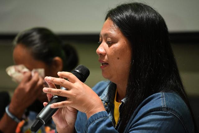 Trixy Elle (R), a survivor, recounts her experience of Super Typhoon Rai, while Regena Torrejas (L) reacts during a press conference at a hotel in Manila on December 11, 2025. Survivors of a deadly 2021 typhoon in the Philippines filed a UK lawsuit against British oil giant Shell, seeking financial compensation for climate-related devastation, three NGOs supporting claimants announced December 11. (Photo by Ted ALJIBE / AFP)