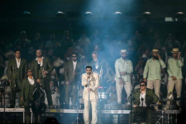 Puerto Rican rapper Bad Bunny performs on stage during his "Debi tirar mas fotos" world tour in Mexico City on December 10, 2025. (Photo by Alfredo ESTRELLA / AFP)