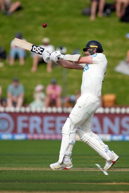 New Zealand's Jacob Duffy plays a shot during day two of the 2nd international Test cricket match between New Zealand and West Indies at the Basin reserve in Wellington on December 11, 2025. (Photo by Marty MELVILLE / AFP)