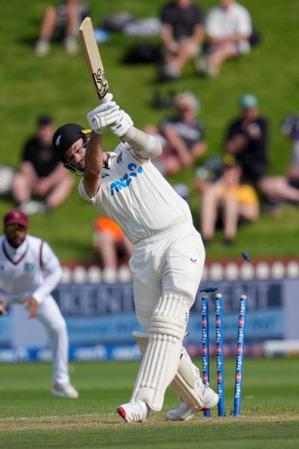New Zealand's Michael Rae is bowled during day two of the 2nd international Test cricket match between New Zealand and West Indies at the Basin reserve in Wellington on December 11, 2025. (Photo by Marty MELVILLE / AFP)