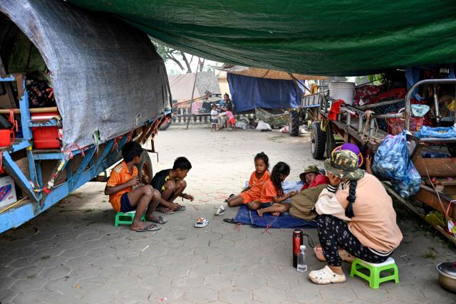 Displaced residents rest at a temporary camp set up at a pagoda during clashes along the Cambodia-Thailand border in Cambodia's Siem Reap province on December 11, 2025. Renewed fighting raged at the border of Cambodia and Thailand on December 11, with combat heard near centuries-old temples, ahead of an expected phone call from US President Donald Trump to the two nations' leaders. (Photo by TANG CHHIN Sothy / AFP)