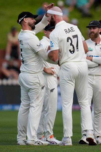 New Zealand Michael Rae (R) celebrates West Indies Brandon King being caught with teammate Daryl Mitchell (L) during day two of the 2nd international Test cricket match between New Zealand and West Indies at the Basin reserve in Wellington on December 11, 2025. (Photo by Marty MELVILLE / AFP)