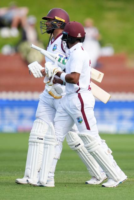 West Indies' Kavem Hodge (L) and teammate Brandon King walk from the field at the end of play during day two of the 2nd international Test cricket match between New Zealand and West Indies at the Basin reserve in Wellington on December 11, 2025. (Photo by Marty MELVILLE / AFP)