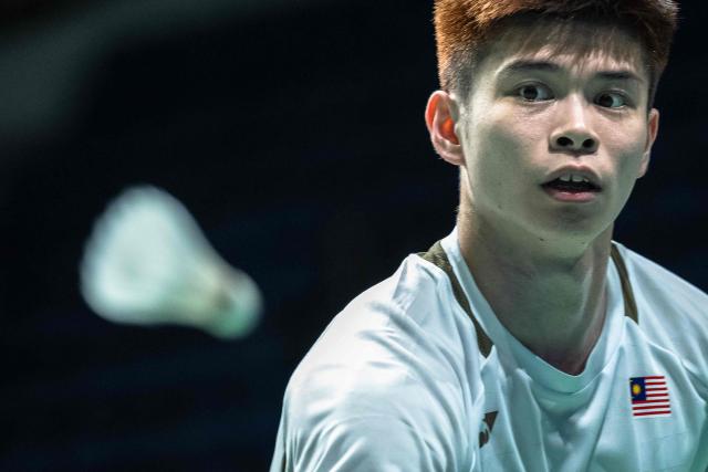 Malaysia's Leong Jun Hao eyes the ball as he hits a return to Laos' Vixunnalath Phichith in their men's single badminton match during the 33rd Southeast Asian Games (SEA Games) at Thammasat Rangsit in Pathum Thani near Bangkok on December 11, 2025. (Photo by Chanakarn LAOSARAKHAM / AFP)