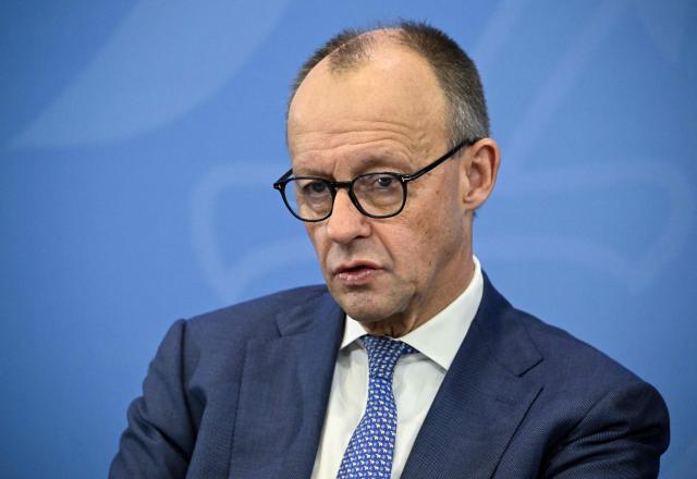 German Chancellor Friedrich Merz attends a press briefing on the results of their overnight coalition committee consultations, on December 11, 2025 at the Chancellery in Berlin. (Photo by Tobias SCHWARZ / AFP)