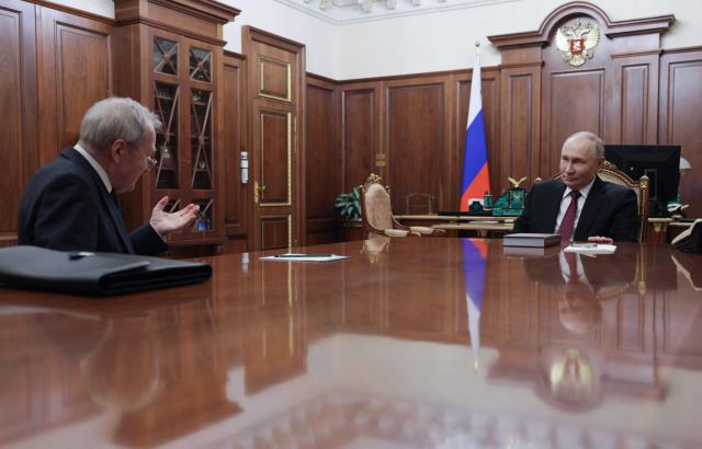 In this pool photograph distributed by the Russian state agency Sputnik, Russia's President Vladimir Putin meets with the Constitutional Court Chairman Valery Zorkin at the Kremlin in Moscow on December 11, 2025. (Photo by Gavriil Grigorov / POOL / AFP)