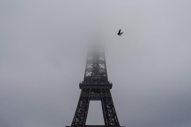 This photograph shows the Eiffel Tower on a foggy day in Paris on December 11, 2025. (Photo by Dimitar DILKOFF / AFP)