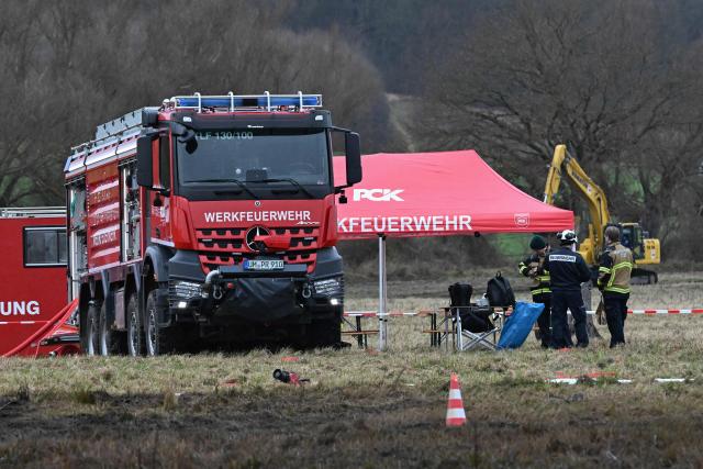 Members of the emergency services clean up following a leak in an oil pipeline of the PCK refinery in Gramzow, eastern Germany on December 11, 2025. The PCK refinery near the border with Poland is majority-owned by Rosneft Deutschland, a local subsidiary of the Russian oil giant, and managed through a trusteeship by the German government (Photo by RALF HIRSCHBERGER / AFP)