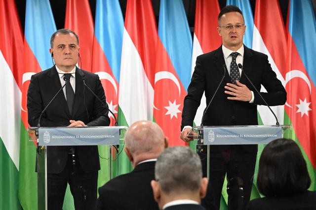 Azerbaijan's Foreign Minister Jeyhun Bayramov (L) and Hungary's Foreign Minister Peter Szijjarto address a joint press conference in the Bozsik Arena of Budapest, on December 11, 2025. Bayramov pays a working visit to the Hungarian capital, including meetings with Hungarian officials and the third Azerbaijan–Hungary Strategic Dialogue. (Photo by Attila KISBENEDEK / AFP)