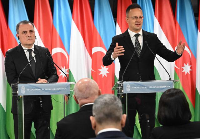 Azerbaijan's Foreign Minister Jeyhun Bayramov (L) and Hungary's Foreign Minister Peter Szijjarto address a joint press conference in the Bozsik Arena of Budapest, on December 11, 2025. Bayramov pays a working visit to the Hungarian capital, including meetings with Hungarian officials and the third Azerbaijan–Hungary Strategic Dialogue. (Photo by Attila KISBENEDEK / AFP)