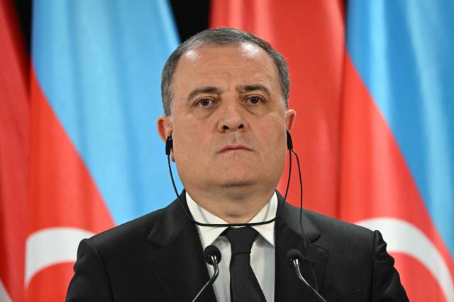 Azerbaijan's Foreign Minister Jeyhun Bayramov listens to the translation during a joint press conference with his Hungarian counterpart in the Bozsik Arena of Budapest, on December 11, 2025. Bayramov pays a working visit to the Hungarian capital, including meetings with Hungarian officials and the third Azerbaijan–Hungary Strategic Dialogue. (Photo by Attila KISBENEDEK / AFP)
