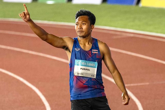 Thailand's Puripol Boonson celebrates winning the men's 100m final of the athletics event during the 33rd Southeast Asian Games (SEA Games) at the Suphachalasai National Stadium in Bangkok on December 11, 2025. (Photo by Chanakarn LAOSARAKHAM / AFP)