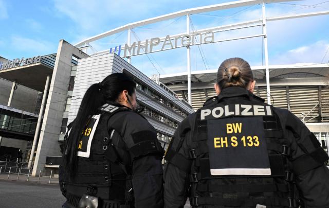 Police officers stand in front of the MHP-Arena prior to the UEFA Europa League football match between VfB Stuttgart and Maccabi Tel Aviv in Stuttgart, southern Germany, on December 11, 2025. (Photo by THOMAS KIENZLE / AFP)
