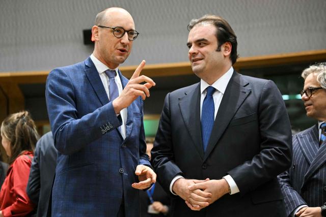 Candidates for the Eurogroup Presidency : Belgium's Finance Minister Vincent Van Peteghem (L) and Greece's  Economy and Finance Minister Kyriakos Pierrakakis (R), speak at the start of a meeting with finance ministers of the Eurozone to elect the new Eurogroup President and discuss the overall budgetary situation and the prospects of euro area, at the European Commission, in Brussels, on December 11, 2025. (Photo by NICOLAS TUCAT / AFP)