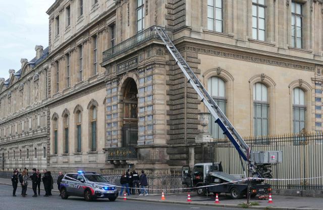 AFP PICTURES OF THE YEAR 2025

French police officers stand next to a furniture elevator used by robbers to enter the Louvre Museum, on Quai Francois Mitterrand, in Paris on October 19, 2025.. Robbers broke in to the Louvre and fled with jewellery on October 19, 2025 morning, a source close to the case said, adding that its value was still being evaluated. A police source said an unknown number of thieves arrived on a scooter armed with small chainsaws and used a goods lift to reach the room they were targeting. (Photo by Dimitar DILKOFF / AFP) / AFP PICTURES OF THE YEAR 2025
