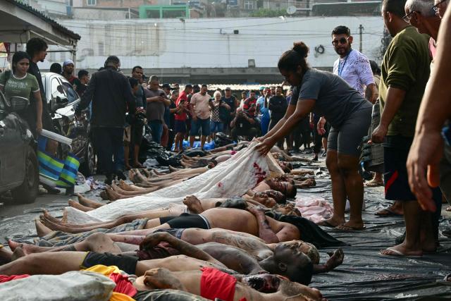 EDITORS NOTE: Graphic content / AFP PICTURES OF THE YEAR 2025

People line up bodies on Sao Lucas Square of the Vila Cruzeiro favela at the Penha complex in Rio de Janeiro, Brazil, on October 29, 2025, in the aftermath of Operacao Contencao (Operation Containment).. Residents of a favela in Rio de Janeiro lined up more than 50 bodies at a plaza in their low-income neighborhood on Ocotber 29, a day after the bloodiest police operation in the city's history, AFP reported. (Photo by Pablo PORCIUNCULA / AFP) / AFP PICTURES OF THE YEAR 2025