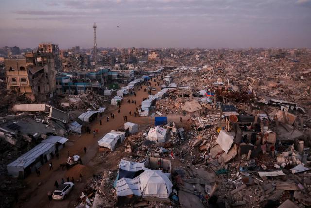 AFP PICTURES OF THE YEAR 2025

Palestinians walk past tents lining the streets amid the rubble of destroyed buildings in Jabalia, in the northern Gaza Strip on February 18, 2025, as people return to northern parts of Gaza during a current ceasefire deal in the war between Israel and Hamas.. Israeli Prime Minister Benjamin Netanyahu said on February 17, that he was "committed" to US President Donald Trump's plan for Gaza, which involves displacing more than two million inhabitants of the Palestinian territory. (Photo by Omar AL-QATTAA / AFP) / AFP PICTURES OF THE YEAR 2025