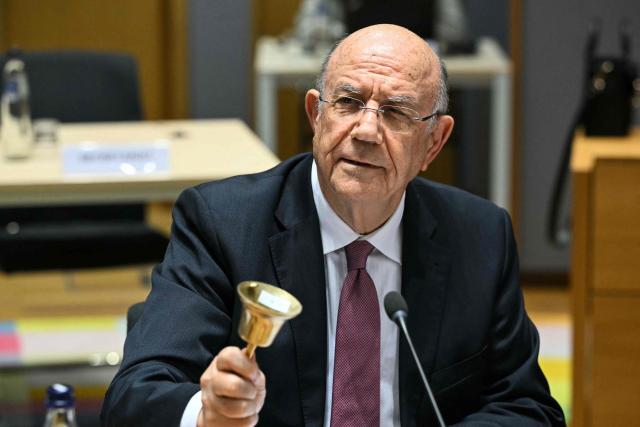 Cyprus's Finance Minister and Acting President of the Eurogroup Makis Keravnos rings the bell at the start of a meeting with finance ministers of the Eurozone to elect the new Eurogroup President and discuss the overall budgetary situation and the prospects of euro area, at the European Commission, in Brussels, on December 11, 2025. (Photo by NICOLAS TUCAT / AFP)