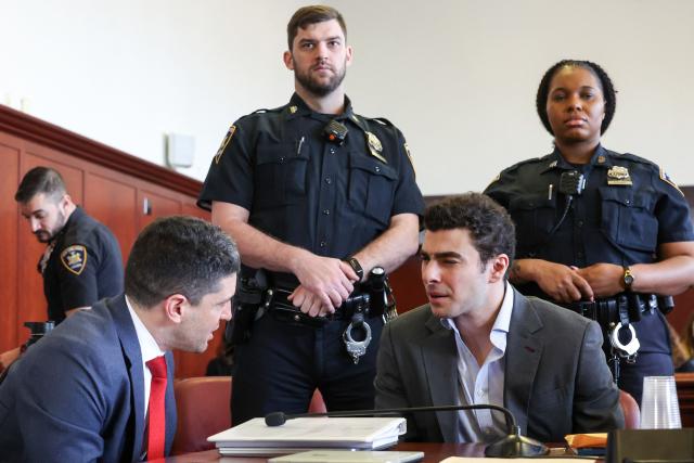 Luigi Mangione (R) appears in Manhattan Supreme Court during an evidentiary hearing in the murder case of United Healthcare CEO Brian Thompson, in New York, on December 11, 2025. (Photo by William Farrington / POOL / AFP)