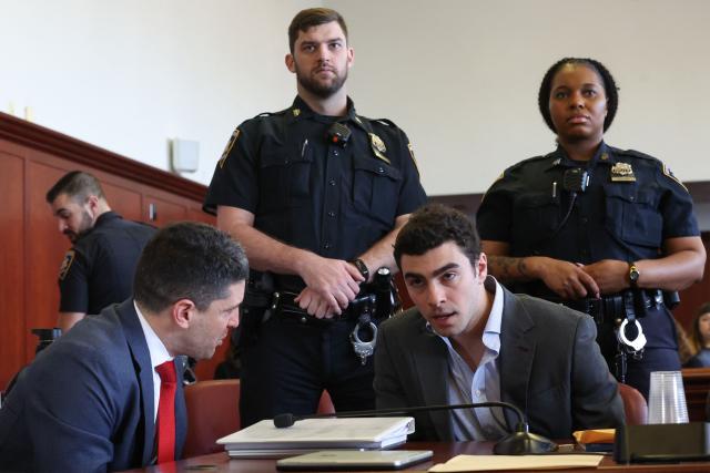 Luigi Mangione (R) appears in Manhattan Supreme Court during an evidentiary hearing in the murder case of United Healthcare CEO Brian Thompson, in New York, on December 11, 2025. (Photo by William Farrington / POOL / AFP)