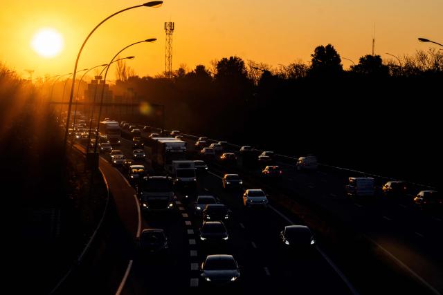 (FILES) This photograph shows cars in a heavy traffic as the sun rise on the road ring (peripherique) in Toulouse, southwestern France on February 6, 2025. France is prepared to accept “targeted flexibilities” in the ban on the sale of new combustion engine and hybrid cars in the European Union from 2035, provided that they are accompanied by regulations encouraging production in Europe, according to a letter from five ministers seen by AFP on December 10, 2025. (Photo by Lionel BONAVENTURE / AFP)
