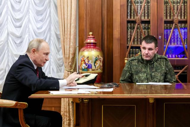 TOPSHOT - In this pool photograph distributed by Russian state agency Sputnik, Russia's President Vladimir Putin (L) and Commander of the 123rd Motorised Rifle Brigade Denis Pirogov (R) take part in a meeting regarding the situation in the area of the so-called "special military operation" in Ukraine with Russian military officials via video link in Moscow on December 11, 2025. Russia said on December 11, 2025 its troops had seized full control of Siversk, a Ukrainian city in the eastern Donetsk region, one of the key settlements where fighting has intensified in recent weeks. (Photo by Gavriil GRIGOROV / POOL / AFP)