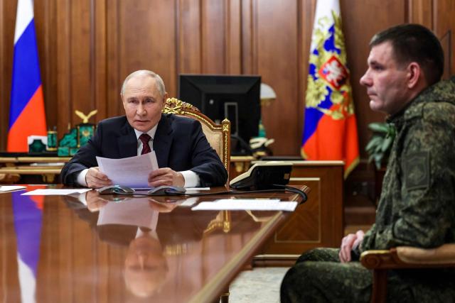 In this pool photograph distributed by Russian state agency Sputnik, Russia's President Vladimir Putin (L) and Commander of the 123rd Motorised Rifle Brigade Denis Pirogov (R) take part in a meeting regarding the situation in the area of the so-called "special military operation" in Ukraine with Russian military officials via video link in Moscow on December 11, 2025. Russia said on December 11, 2025 its troops had seized full control of Siversk, a Ukrainian city in the eastern Donetsk region, one of the key settlements where fighting has intensified in recent weeks. (Photo by Gavriil GRIGOROV / POOL / AFP)