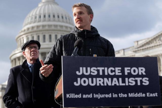 Agence France-Presse (AFP) video journalist Dylan Collins speaks about his experience being wounded during an Israeli attack on a group of seven journalists in Southern Lebanon on October 13, 2023, alongside US Senator Peter Welch (L), Democrat of Vermont, as members of Congress, along with Amnesty International USA and the Committee to Protect Journalists, present their findings into the attack, during a press conference outside the US Capitol in Washington, DC, December 11, 2025. A Reuters video journalist was killed in the strike and an AFP photojournalist was gravely wounded, resulting in the amputation of her right leg. (Photo by SAUL LOEB / AFP)