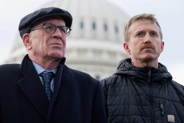 US Senator Peter Welch (L), Democrat of Vermont, stands alongside Agence France-Presse (AFP) video journalist Dylan Collins (R), who was wounded during an Israeli attack on a group of seven journalists in Southern Lebanon on October 13, 2023, as members of Congress, along with Amnesty International USA and the Committee to Protect Journalists, present their findings into the attack, during a press conference outside the US Capitol in Washington, DC, December 11, 2025. A Reuters video journalist was killed in the strike and an AFP photojournalist was gravely wounded, resulting in the amputation of her right leg. (Photo by SAUL LOEB / AFP)
