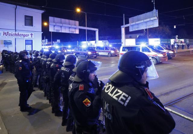 Riot police observe as the fans of Red Star Belgrade make their way to the stadium prior to the UEFA Europa League football match between SK Sturm Graz and Crvena Zvezda (Red Star Belgrade) in Graz, Austria on December 11, 2025. (Photo by ERWIN SCHERIAU / APA / AFP) / Austria OUT