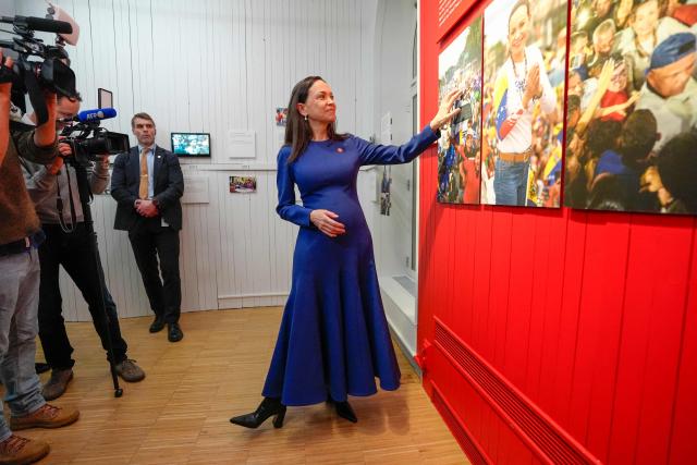 Nobel Peace Prize laureate Maria Corina Machado poses for medias during the opening of the official Peace Prize exhibition at the Nobel Peace Center in Oslo, Norway, on December 11, 2025. - The 58-year-old, who has been in hiding in her home country since June 2024, missed the award of the Nobel Prize in Oslo on December 10. But she waved to supporters from her hotel shortly after arriving during the night. Maria Corina Machado is the lynchpin of opposition to Venezuelan President Nicolas Maduro's regime, a fearless activist with rock star appeal whose inability to attend her own Nobel prize ceremony underlined the dangers she faces. (Photo by Lise Åserud / NTB / AFP) / Norway OUT